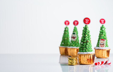 Christmas cupcake, pudding on white table Traditional New Year dessert. Copy space.,x'mas Cake decoration and gift box with Christmas tree concept for banner cover background