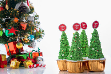 Christmas cupcake, pudding on white table Traditional New Year dessert. Copy space.,x'mas Cake decoration and gift box with Christmas tree concept for banner cover background