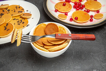 front view yummy little pancakes with red berries on dark background dessert sweet cake