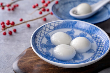 Fototapeta na wymiar Close up of tangyuan in a bowl on gray table, food for Winter Solstice.