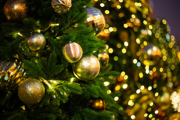 Christmas tree decorations, balls and toys with garland on street at night - close up. Holiday, celebration, traditional and new year concept