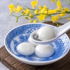 Close up of tangyuan in a bowl on gray table, food for Winter Solstice.