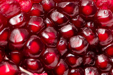 fresh pomegranate seeds macro close-up in drops