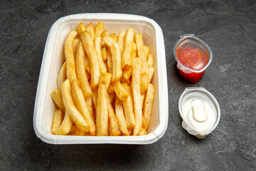 Close up view of french fried potato mayonnaise and ketchup