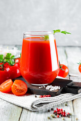  Glass of fresh tomato juice close up on the table