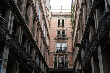 Old historic houses with windows, balconies and streetlight in Barcelona