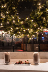 Enjoy two cappuccino with christmas decoration looking through temple bar street
