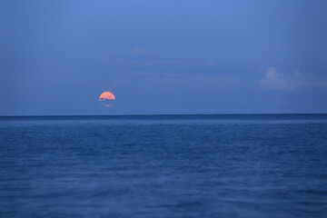 Moonrise in the evening sky by the sea