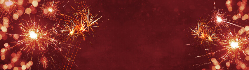 Silvester background panorama banner long - Firework on red texture with bokeh Lights and space for text