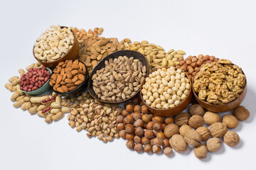 Different types of nuts in composition on white background in studio