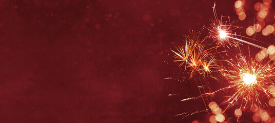 Silvester background panorama banner long - Firework on red texture with bokeh Lights and space for...