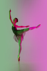 Tender. Young and graceful ballet dancer isolated on gradient pink-green studio background in neon....