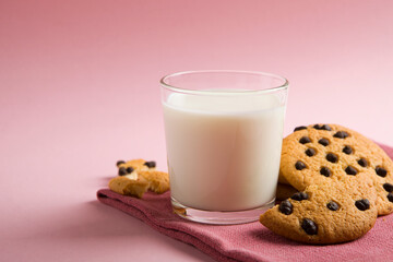 Delicious cookies with chocolate chips on a colored background