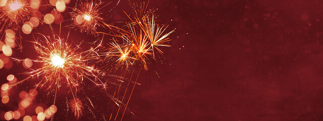 Silvester background panorama banner long - Firework on red texture with bokeh Lights and space for...