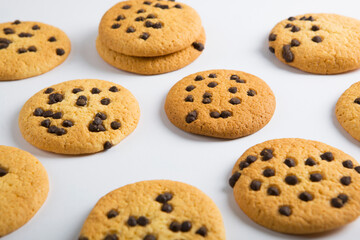 Delicious cookies with chocolate chips on a colored background