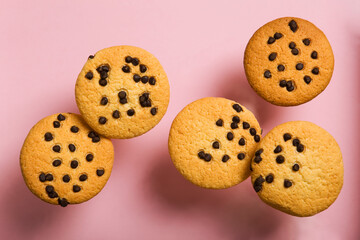 Delicious cookies with chocolate chips on a colored background