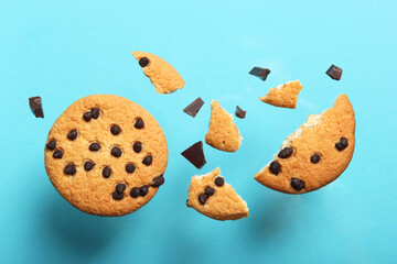 Delicious cookies with chocolate chips on a colored background