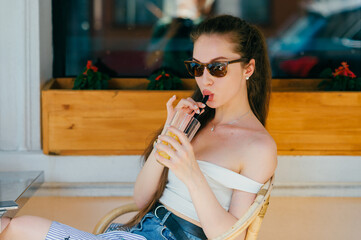 Young glamour sexy woman drinking juice