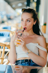 Young glamour sexy woman drinking juice