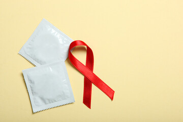 Condoms and red ribbon symbolizing AIDS. World AIDS Day