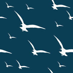 Flying seagulls silhouettes over deep blue background seamless pattern. Minimal. Simple.