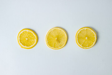 Lemons on a white background. Citrus fruit. Healthy food. Sliced lemon. Sour fruit