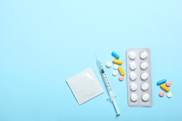 condoms and other contraceptives on a colored background