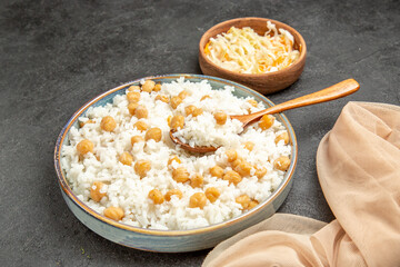 Quick and easy peas and rice meal for dinner with a spoon and sauerkraut on dark background
