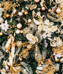 beautiful big Christmas tree decorated with balls and toys holiday christmas mood gifts with ribbons. 