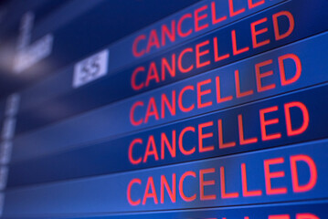 Obraz premium Flight information board displaying cancelled flights in international airport during COVID-19 pandemic