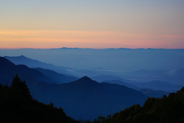 The National park mountain view landscape with foggy in morning sunrise beautiful orange sky background