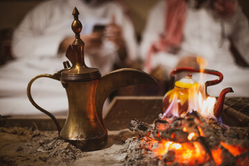 Traditional arabic coffee pot named dallah in fireplace