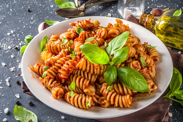Fusilli pasta with tomato sauce and basil