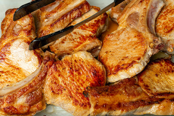 Ready-made pork cutlets on a glass baking sheet