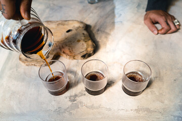 Drip coffee, barista pouring water on coffee ground with filter