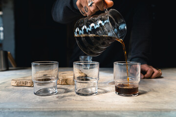 Drip coffee, barista pouring water on coffee ground with filter