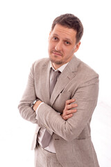 young man  with crossed arms  and with a guilty expression, isolated