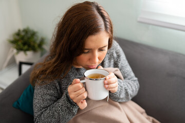 Young woman feeling sick and resting on the couch