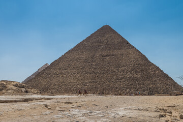 Fototapeta na wymiar The Giza pyramid complex, an archaeological site on the Giza Plateau, on the outskirts of Cairo, Egypt. It includes the three Great Pyramids : Khufu Cheops, Khafre Chephren and Menkaure.