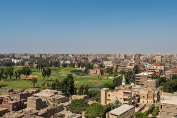 Fototapeta na wymiar Aerial view of Cairo of red brick houses from the Giza pyramid complex, the Giza Necropolis, on the Giza Plateau in Greater Cairo, Egypt