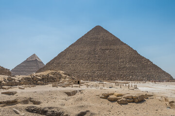 Fototapeta na wymiar The Giza pyramid complex, an archaeological site on the Giza Plateau, on the outskirts of Cairo, Egypt. It includes the three Great Pyramids : Khufu Cheops, Khafre Chephren and Menkaure.