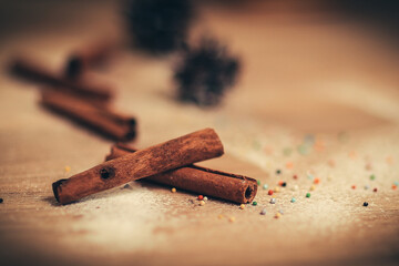 Christmas table. background image of cinnamon sticks on a woode
