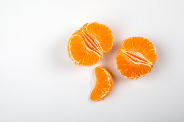 Peeled tangerine fruit, Mandarin pieces on white background