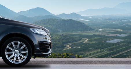 Fototapeta na wymiar SUV car on the background of mountain valley. Copy space