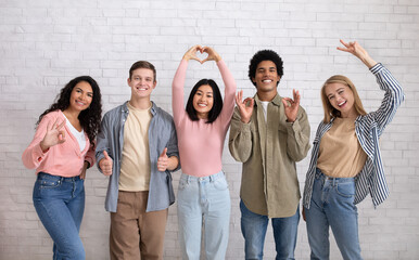 Love, friendship, youth, lifestyle. Teen happy multiracial friends gesturing with hands