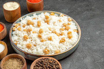 Dinner background with peas and rice meal with different spices mayonnaise ketchup