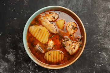 Horizontal top view from above of delicious chicken soup with many ingredients