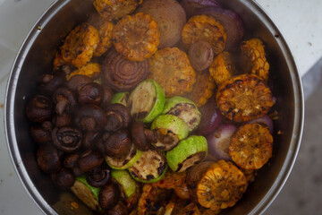 Many different grilled vegetables are in the pan. Vegetarian shish kebab.