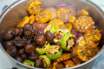 Many different grilled vegetables are in the pan. Vegetarian shish kebab.