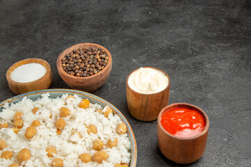 Obraz na płótnie Canvas Half shot view of seasoned split peas and rice meal different spices mayonnaise and ketchup